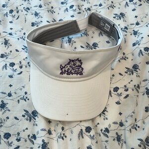 New Era TCU white sun visor with purple horned frog on it.